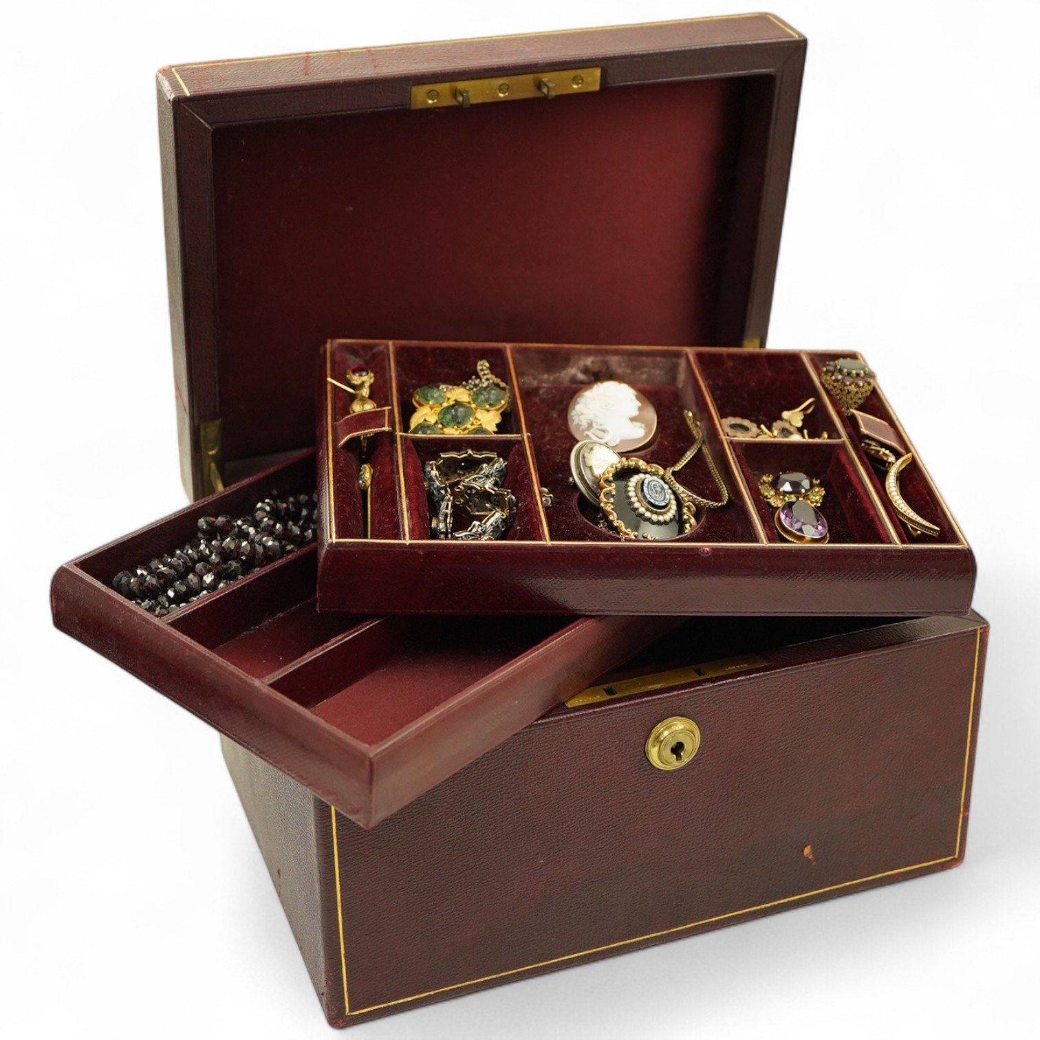 A jewellery case and a collection of jewellery, comprising: an amethyst and peridot pendant in 9ct gold, length 3.8cm, British hallmarks, gross weight approximately 7 grams; a garnet cluster ring in 9ct gold, British hal